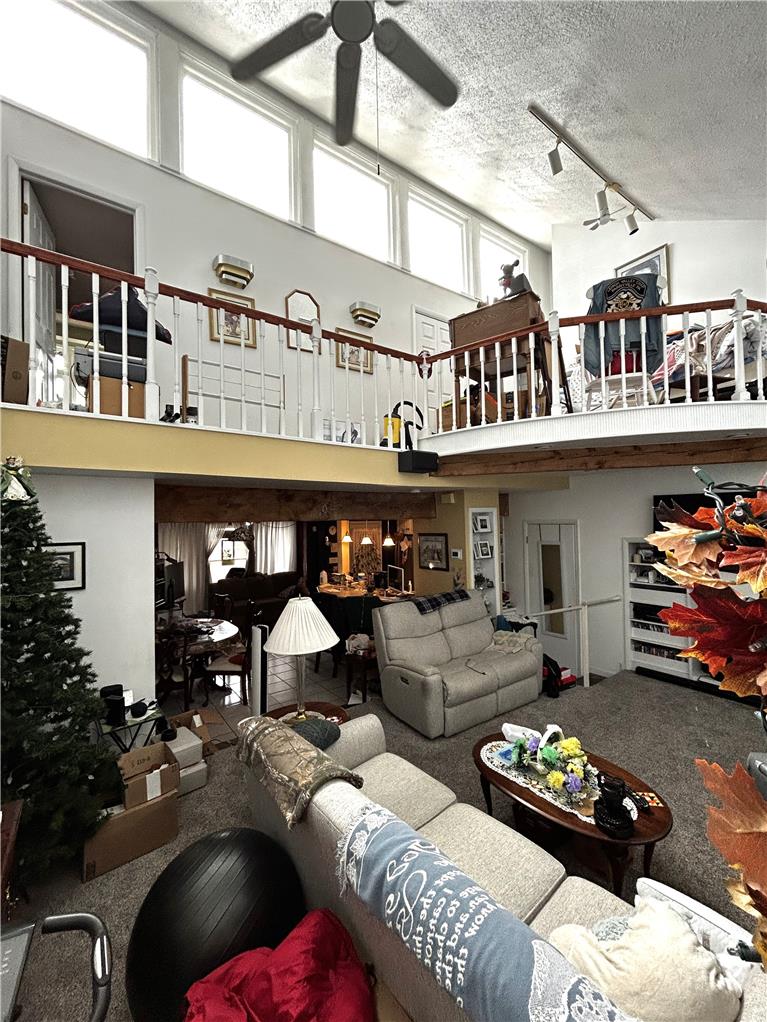 1214 Stanford Road Bethlehem, PA 18018 - Photo 27 of 58 An inviting open-concept living space features a lofted second level and a grand ceiling fan.