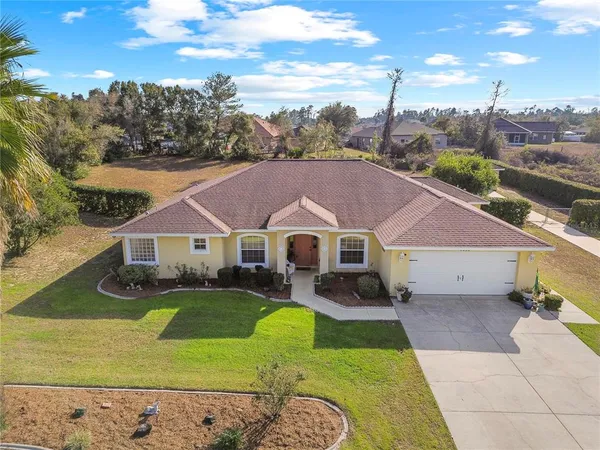 a aerial view of a house with a big yard