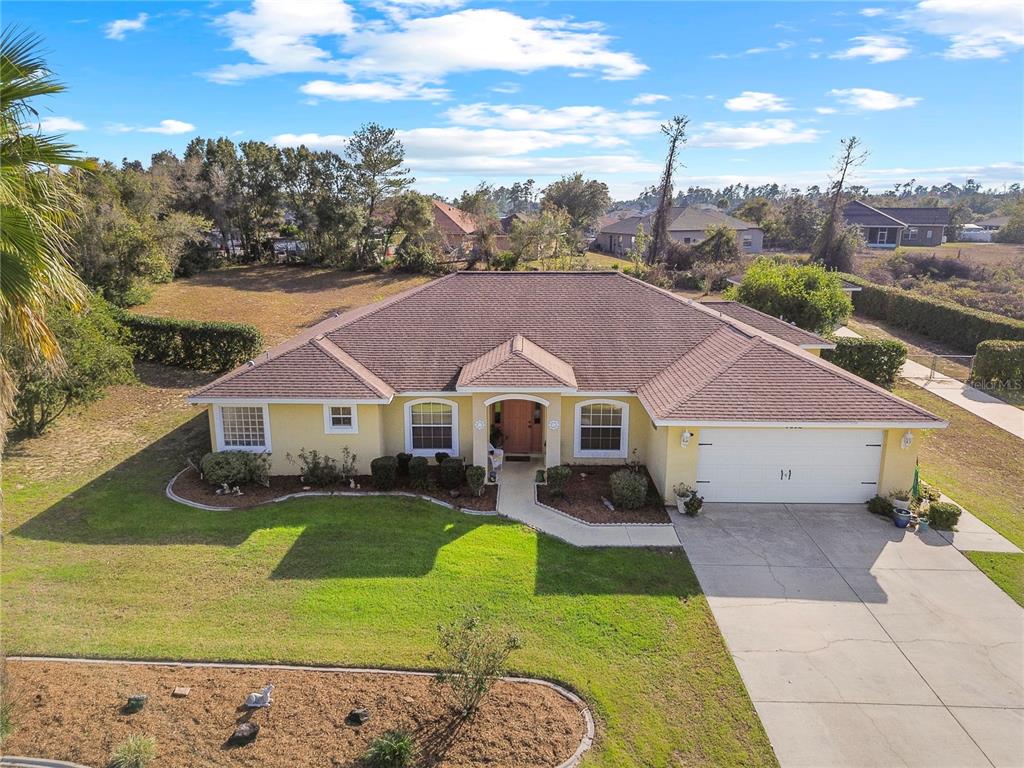 a aerial view of a house with a big yard