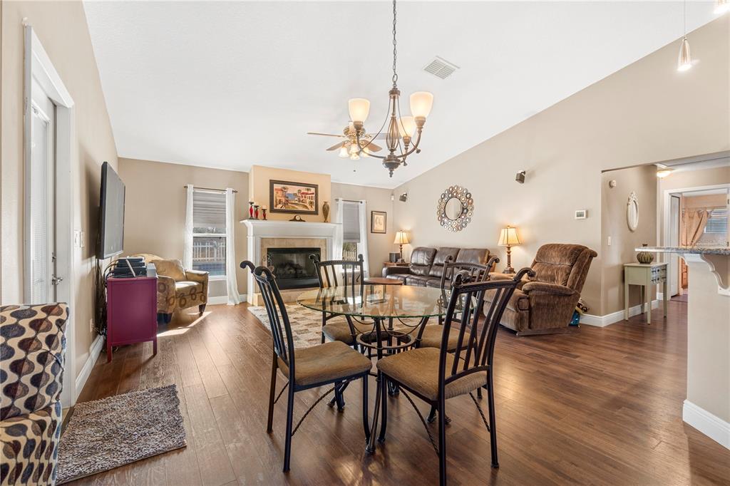 4642 Southwest 100th Lane Ocala, FL 34476 - Photo 14 of 61 a view of a dining room with furniture wooden floor and chandelier