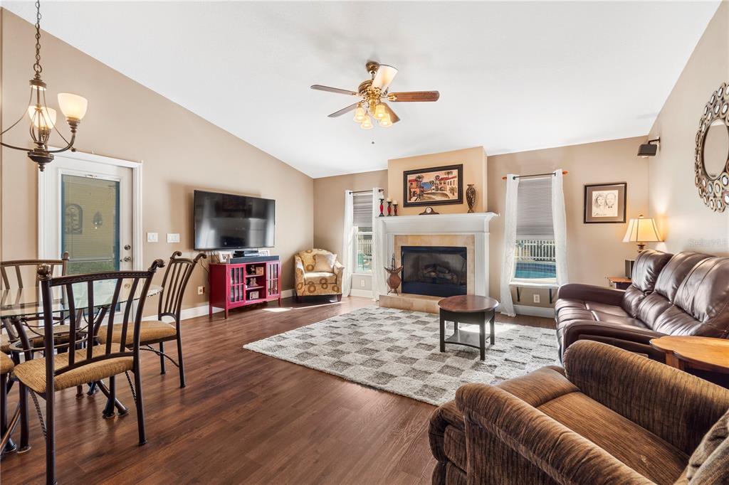 4642 Southwest 100th Lane Ocala, FL 34476 - Photo 15 of 61 a living room with furniture a fireplace and a flat screen tv