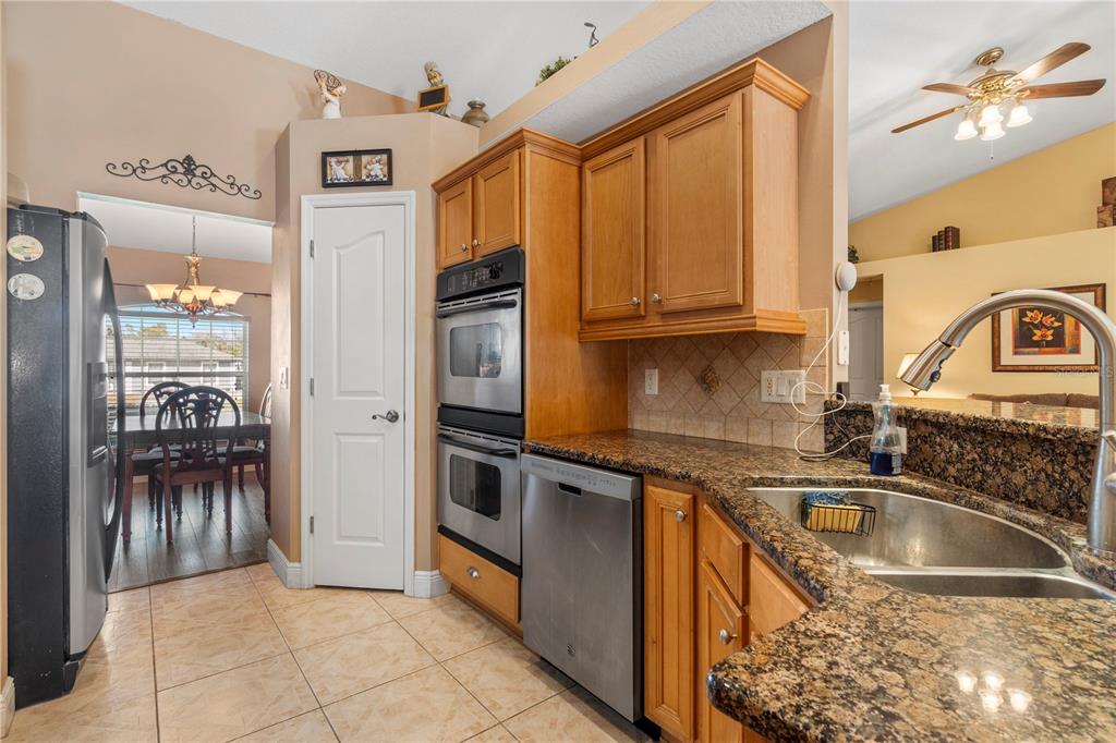 4642 Southwest 100th Lane Ocala, FL 34476 - Photo 18 of 61 a kitchen with granite countertop a refrigerator and a sink