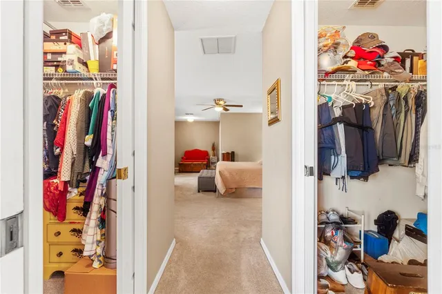 a spacious bedroom with a bed and ceiling fan