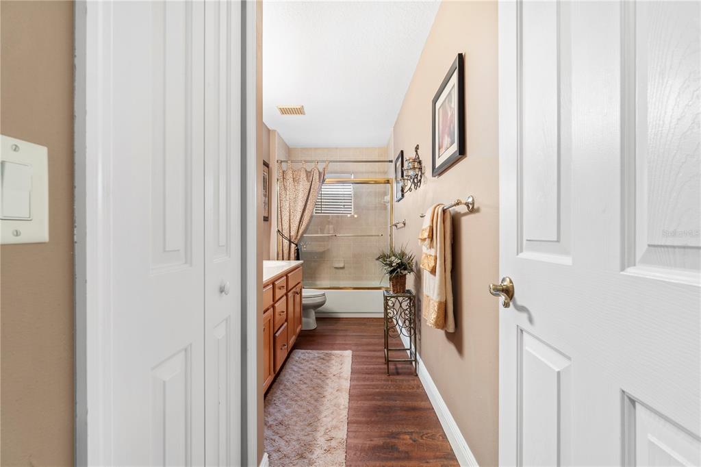 4642 Southwest 100th Lane Ocala, FL 34476 - Photo 29 of 61 a view of a hallway with wooden floor and staircase