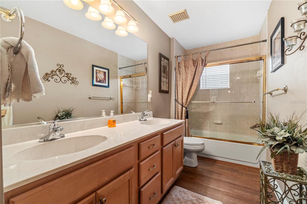 4642 Southwest 100th Lane Ocala, FL 34476 - Photo 30 of 61 a bathroom with a double vanity sink toilet and shower
