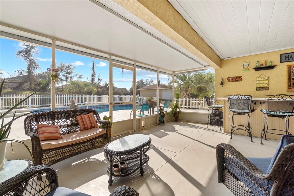 4642 Southwest 100th Lane Ocala, FL 34476 - Photo 41 of 61 a outdoor living space with patio furniture and a potted plant