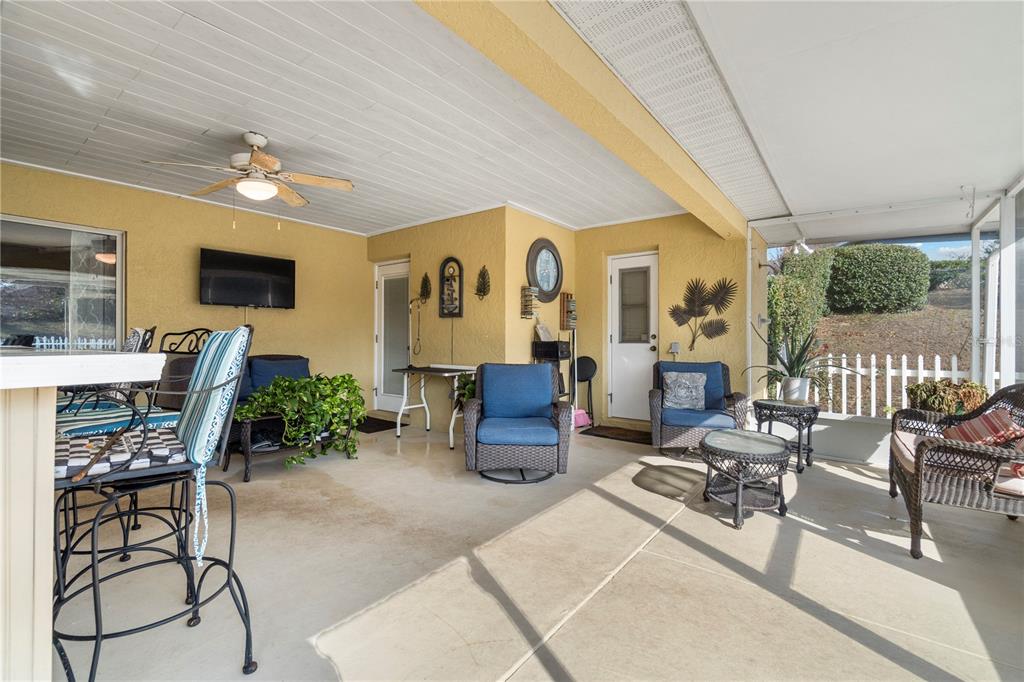 4642 Southwest 100th Lane Ocala, FL 34476 - Photo 42 of 61 a living room with furniture and a flat screen tv