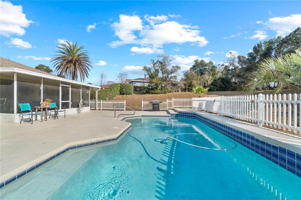 4642 Southwest 100th Lane Ocala, FL 34476 - Photo 47 of 61 a view of a swimming pool with a patio and plants