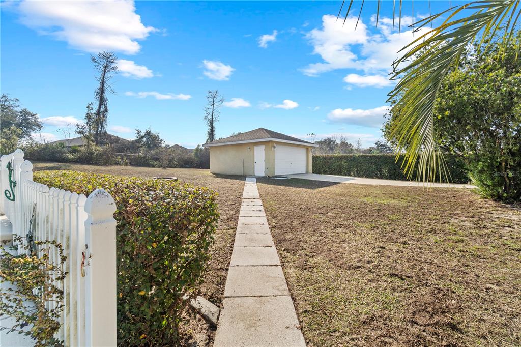 4642 Southwest 100th Lane Ocala, FL 34476 - Photo 50 of 61 a view of a pathway with a wrought fence