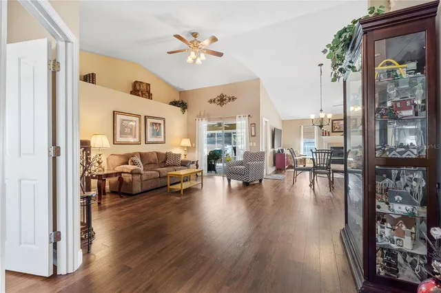 a view of a hallway with wooden floor and windows