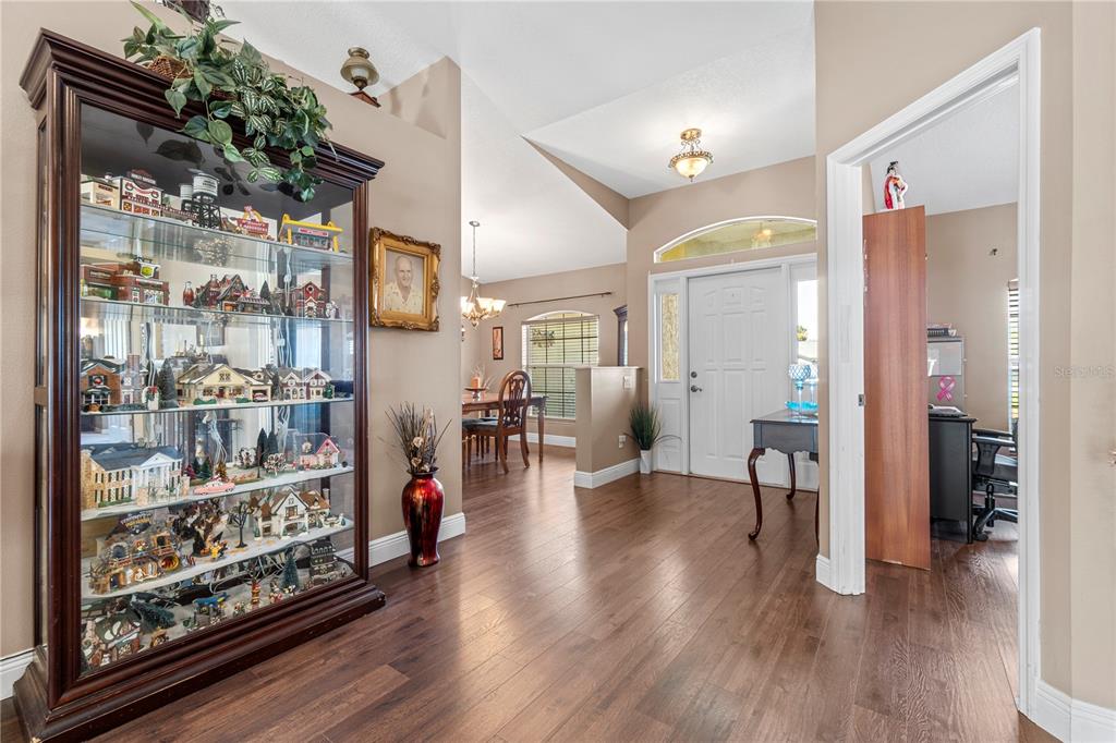 4642 Southwest 100th Lane Ocala, FL 34476 - Photo 8 of 61 a view of a hallway with wooden floor and windows
