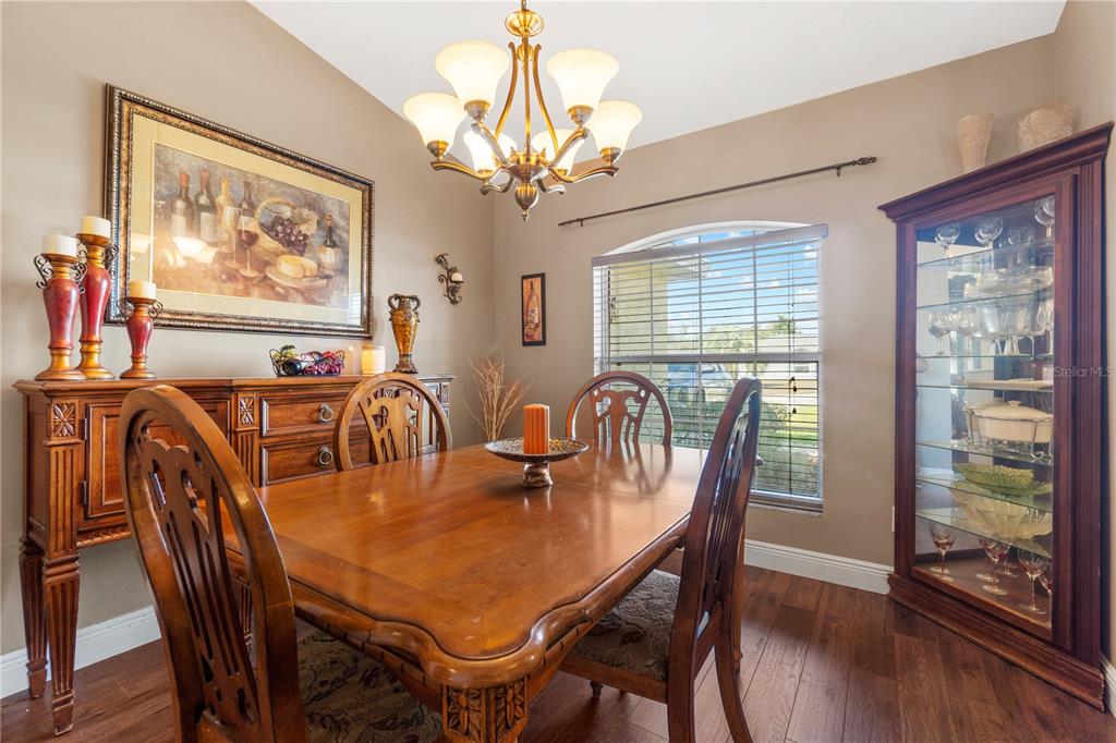 4642 Southwest 100th Lane Ocala, FL 34476 - Photo 10 of 61 a view of a dining room with furniture window and wooden floor