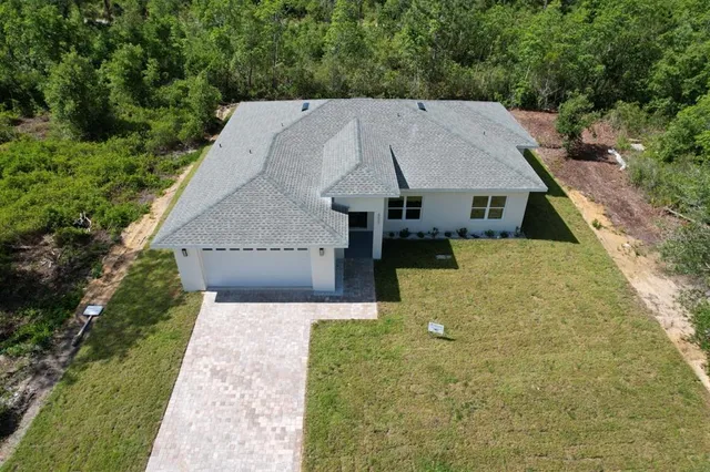 an aerial view of a house with a yard