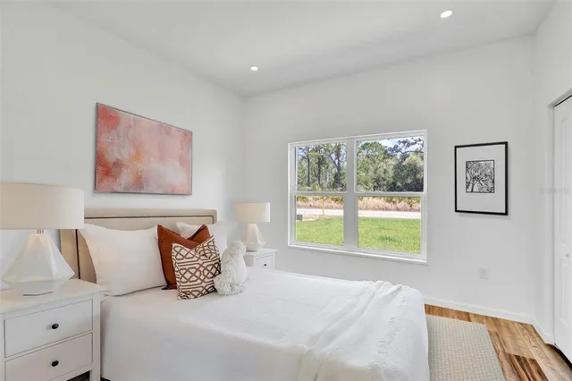 a bedroom with a bed and a window