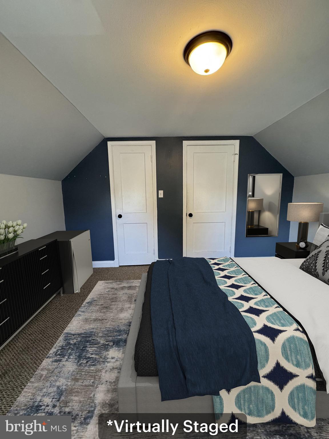 2-7408 Digby Road, Unit 2 Gwynn Oak, MD 21207 - Photo 6 of 12 a bedroom with a bed and a large mirror