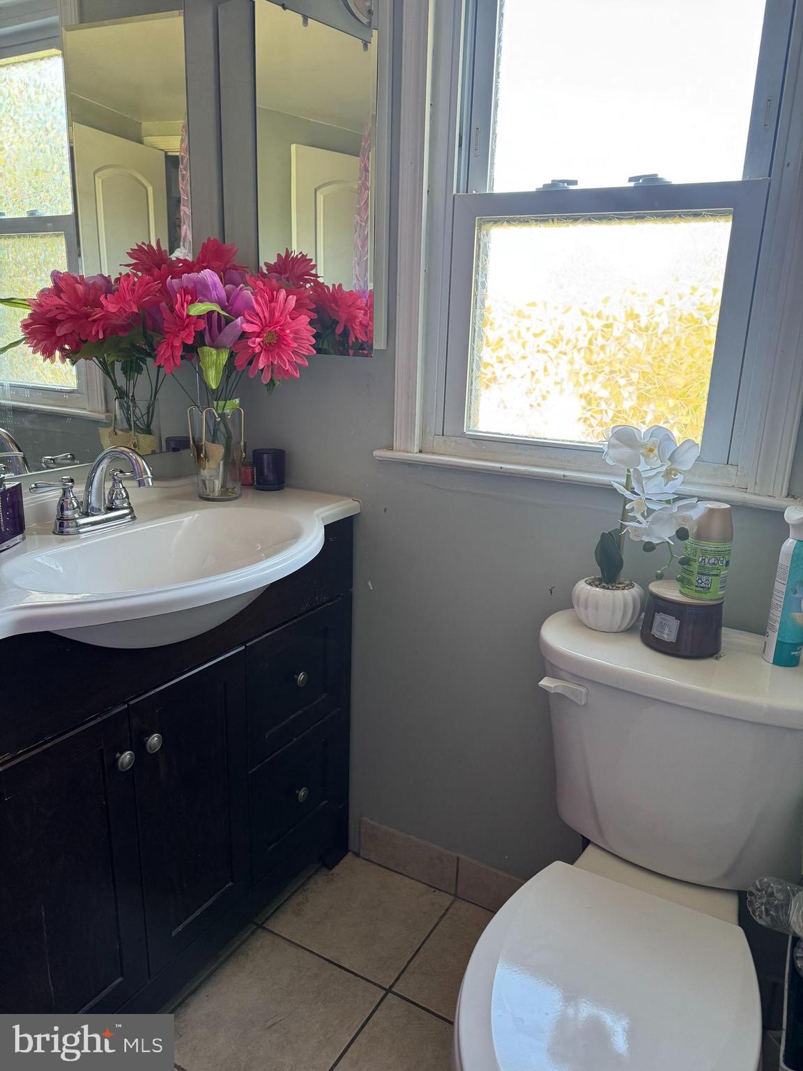 2-7408 Digby Road, Unit 2 Gwynn Oak, MD 21207 - Photo 7 of 12 a bathroom with a sink vanity mirror and toilet