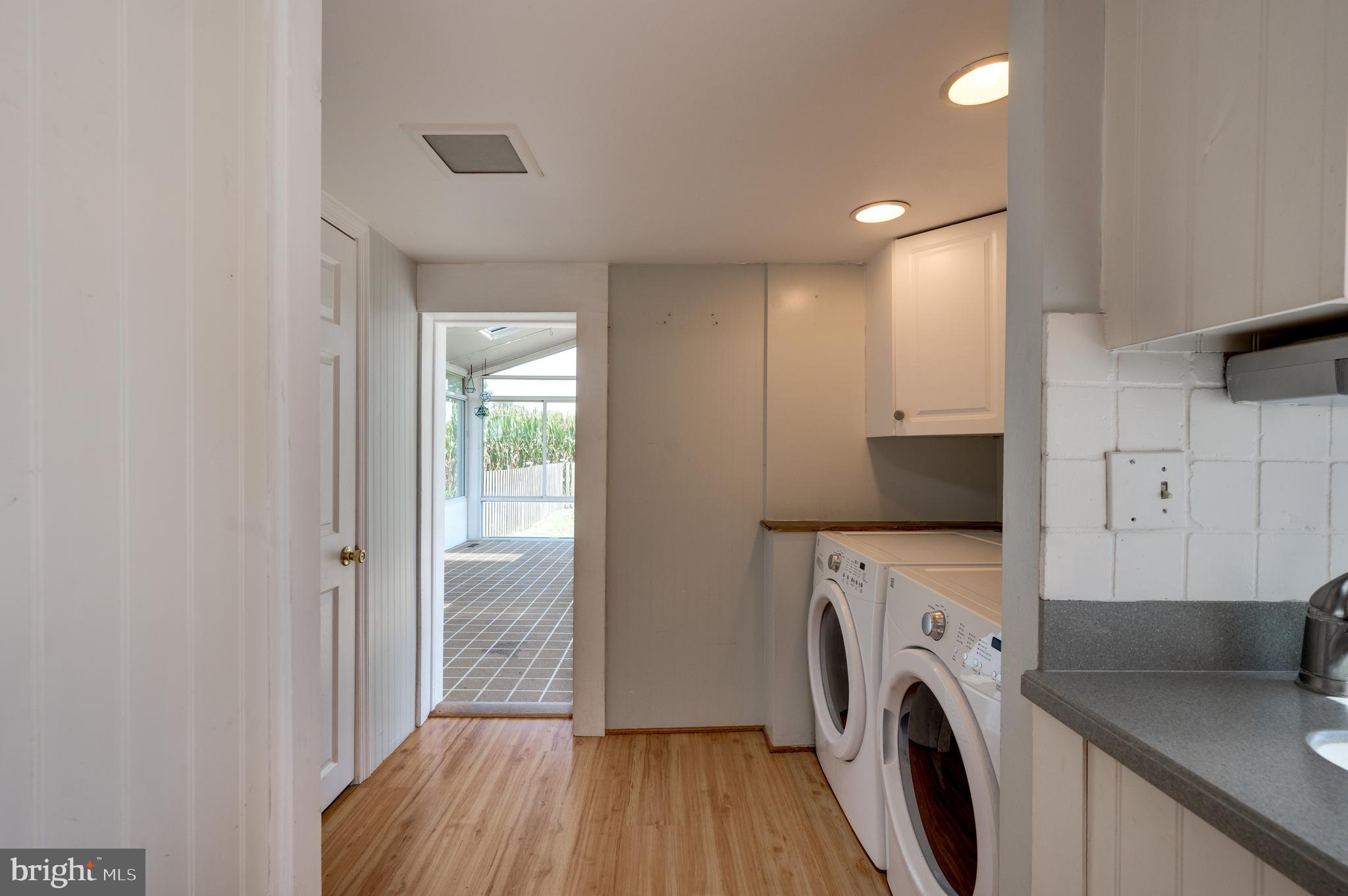 4855 Stonesifer Road Taneytown, MD 21787 - Photo 16 of 65 a view of washer and dryer with kitchen in the background