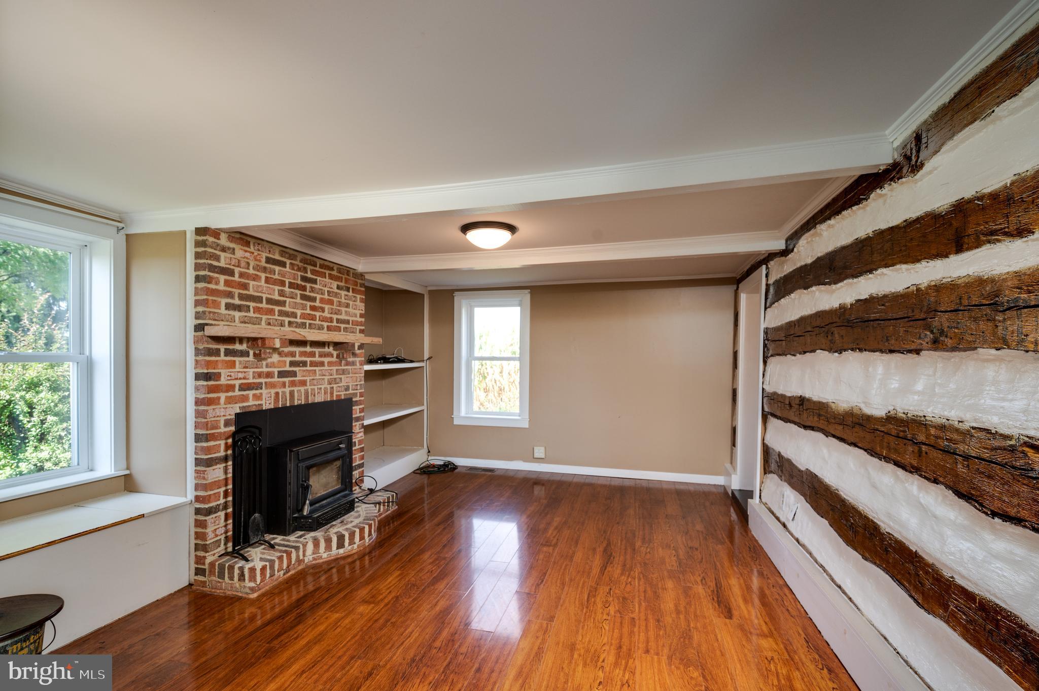 4855 Stonesifer Road Taneytown, MD 21787 - Photo 18 of 65 a view of a livingroom with wooden floor and a fireplace