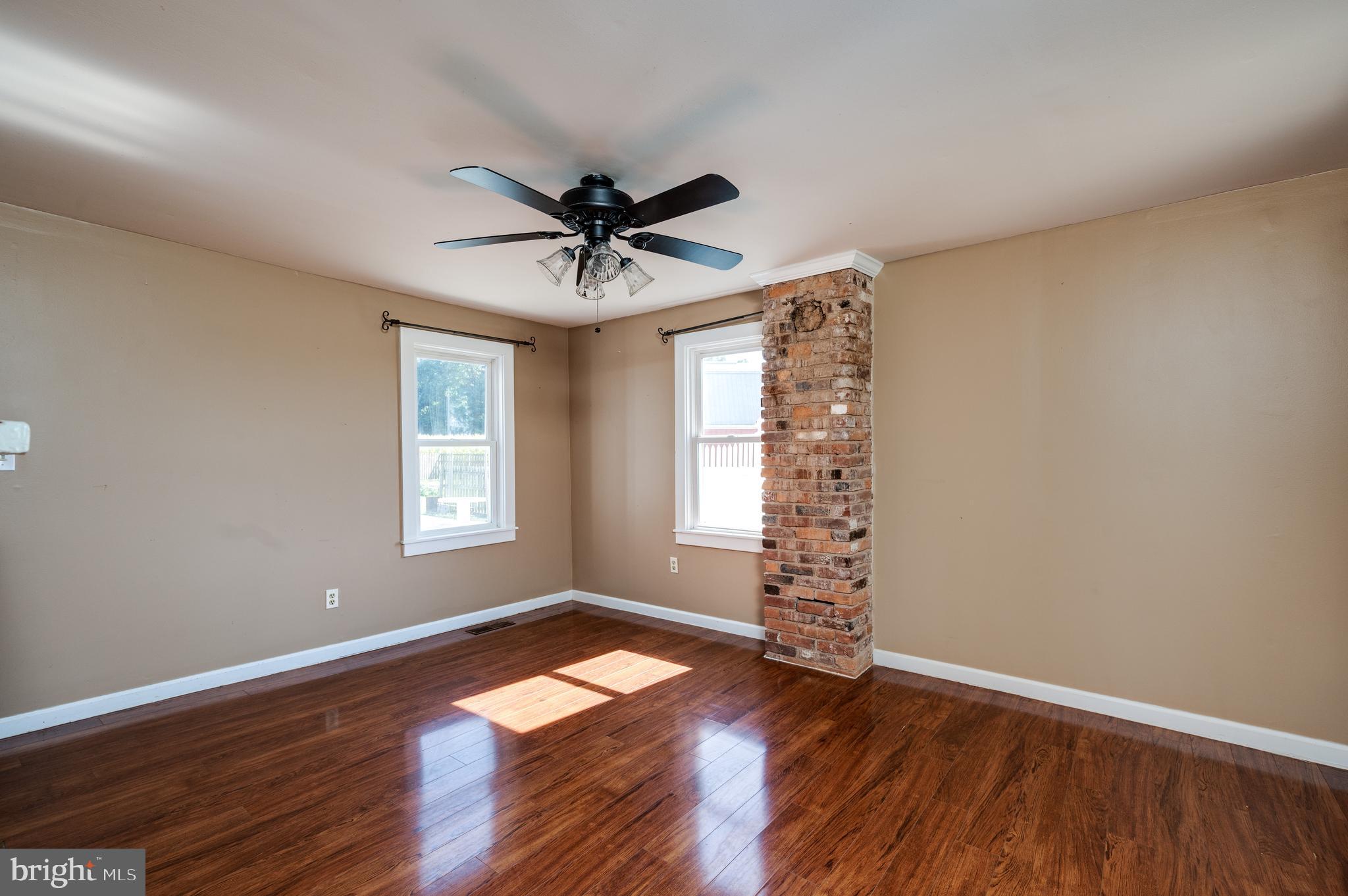 4855 Stonesifer Road Taneytown, MD 21787 - Photo 21 of 65 an empty room with wooden floor chandelier fan and windows