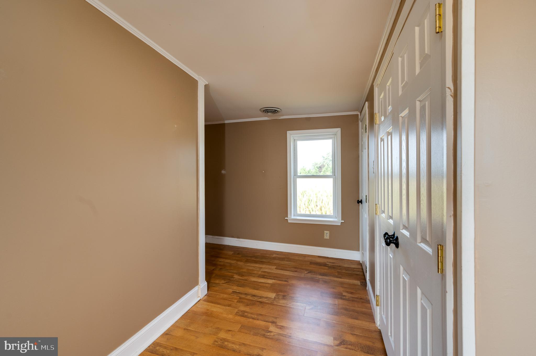 4855 Stonesifer Road Taneytown, MD 21787 - Photo 26 of 65 a view of an empty room with wooden floor and a window