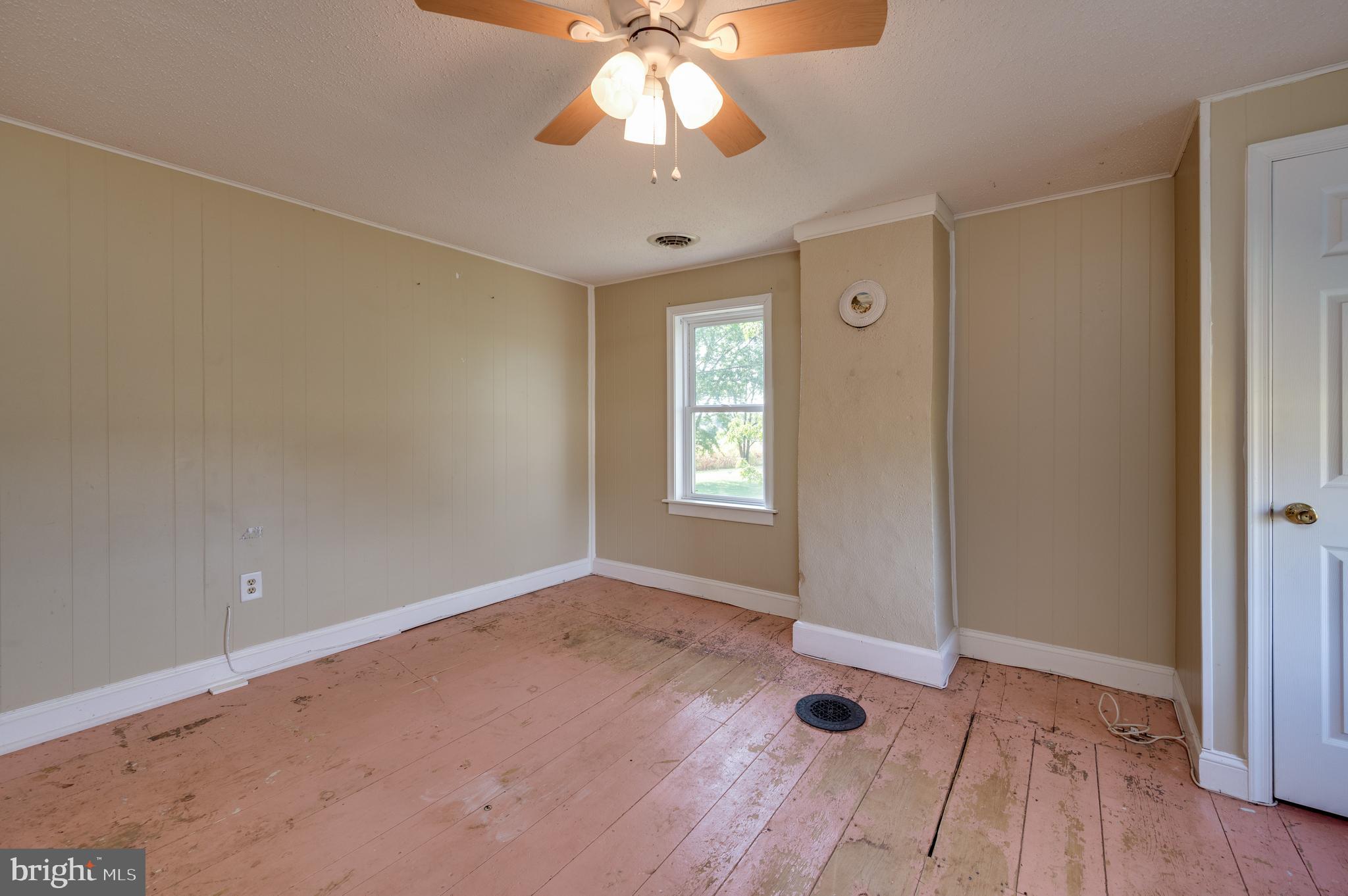 4855 Stonesifer Road Taneytown, MD 21787 - Photo 27 of 65 wooden floor in an empty room with a window