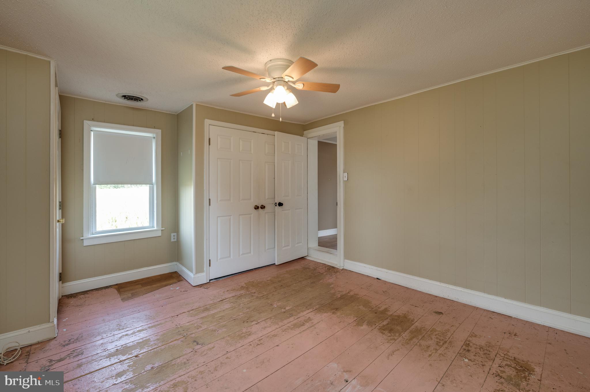4855 Stonesifer Road Taneytown, MD 21787 - Photo 28 of 65 an empty room with wooden floor fan and windows