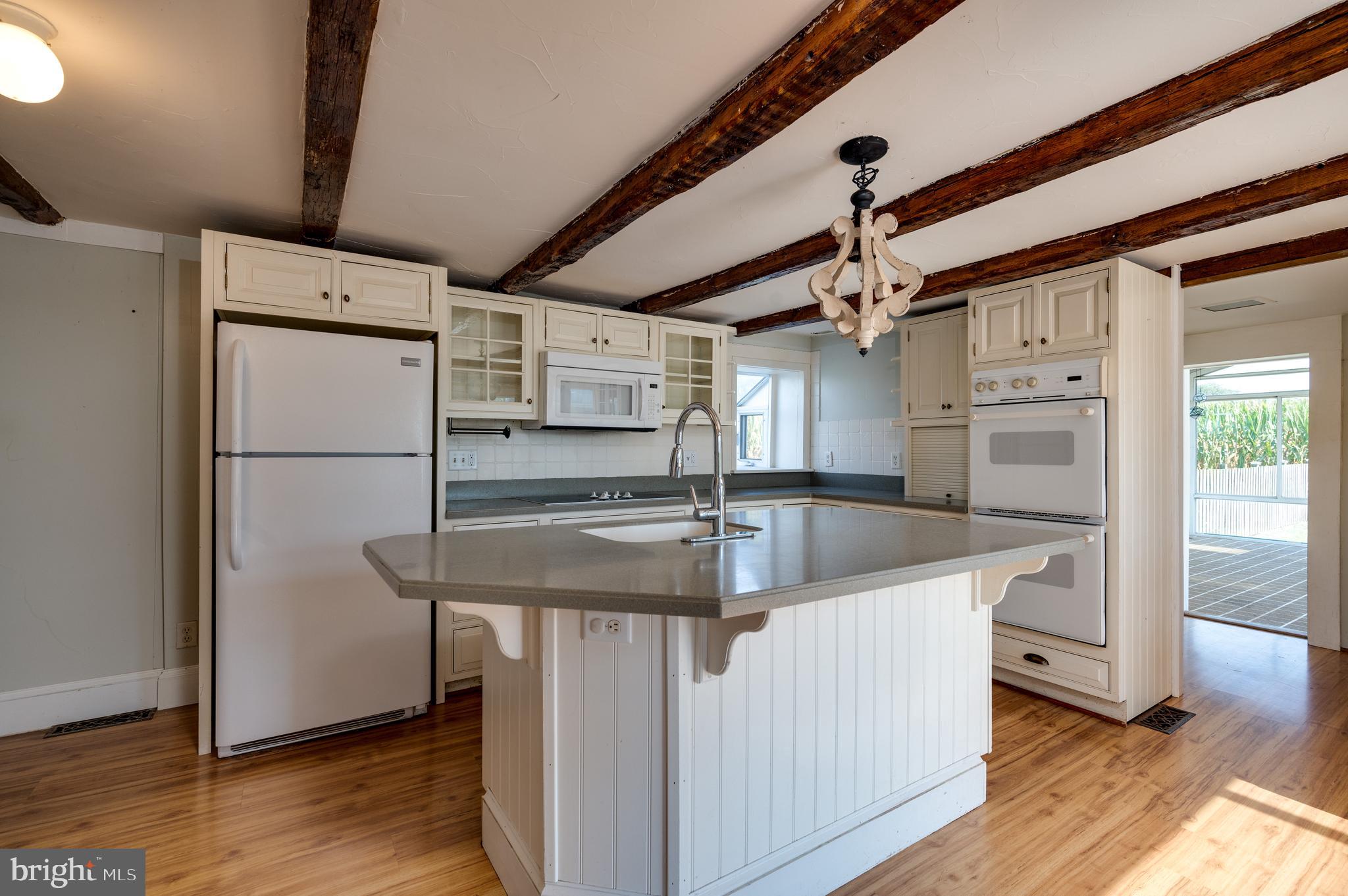 4855 Stonesifer Road Taneytown, MD 21787 - Photo 7 of 65 a kitchen with stainless steel appliances granite countertop a sink a refrigerator and a stove