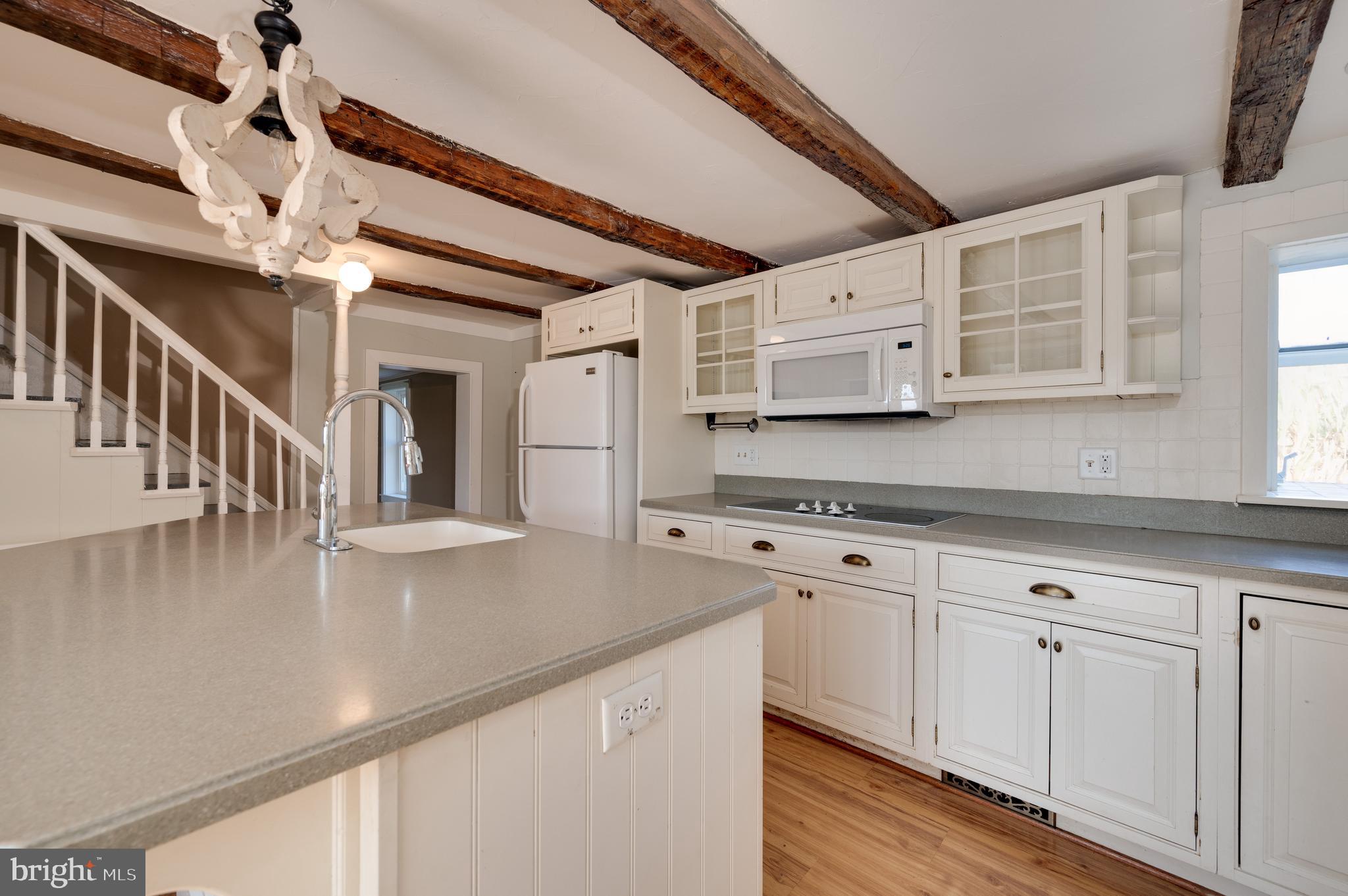 4855 Stonesifer Road Taneytown, MD 21787 - Photo 9 of 65 a view of a kitchen with cabinets and wooden floor
