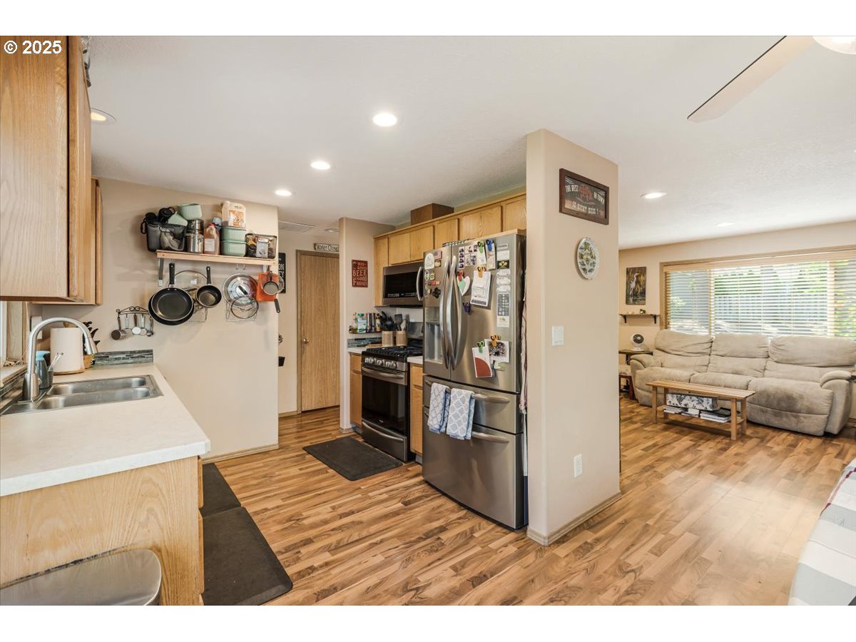 3977 Southeast Salquist Road Gresham, OR 97080 - Photo 11 of 33 a kitchen with refrigerator cabinets and wooden floor