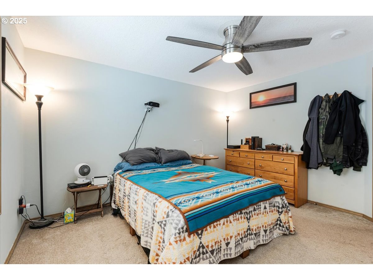 3977 Southeast Salquist Road Gresham, OR 97080 - Photo 16 of 33 a bedroom with a bed and a chandelier