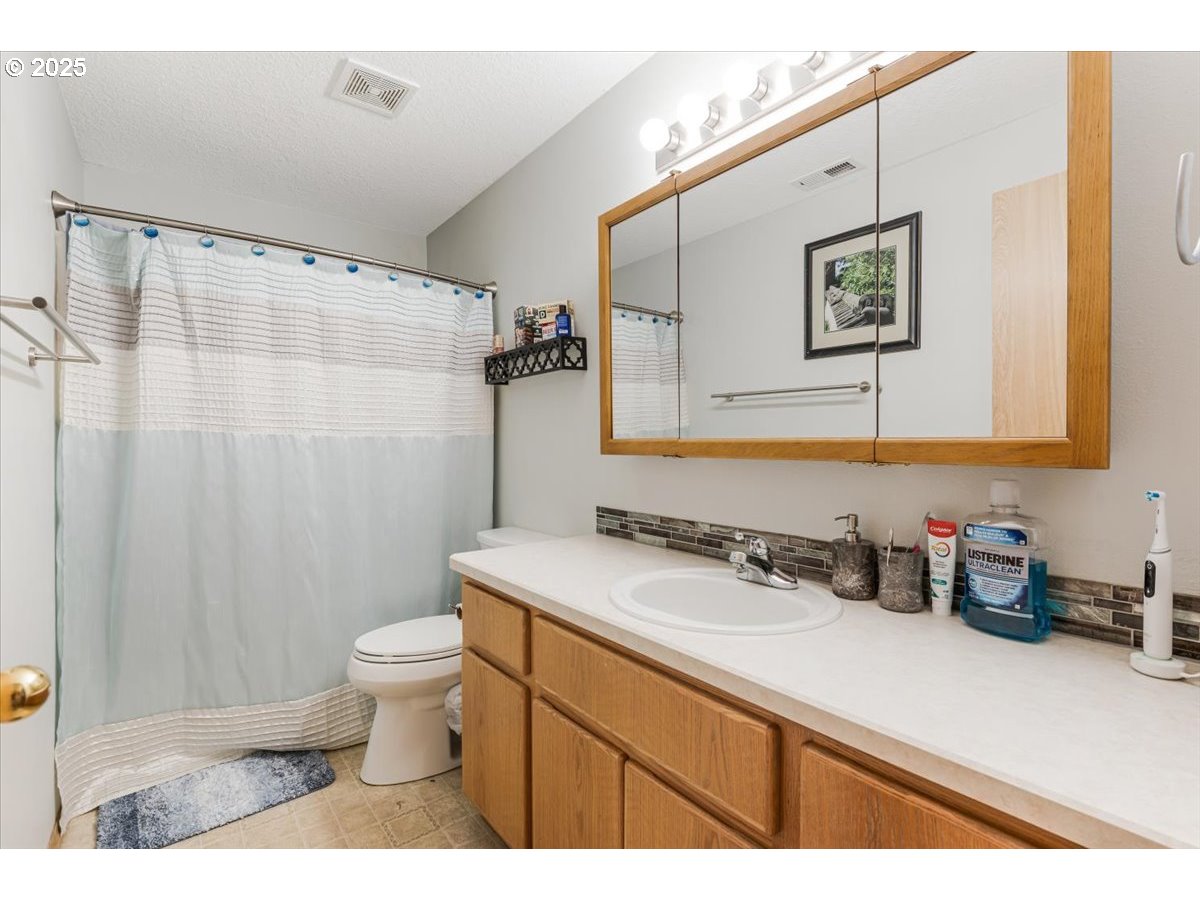 3977 Southeast Salquist Road Gresham, OR 97080 - Photo 17 of 33 a bathroom with a sink toilet and shower