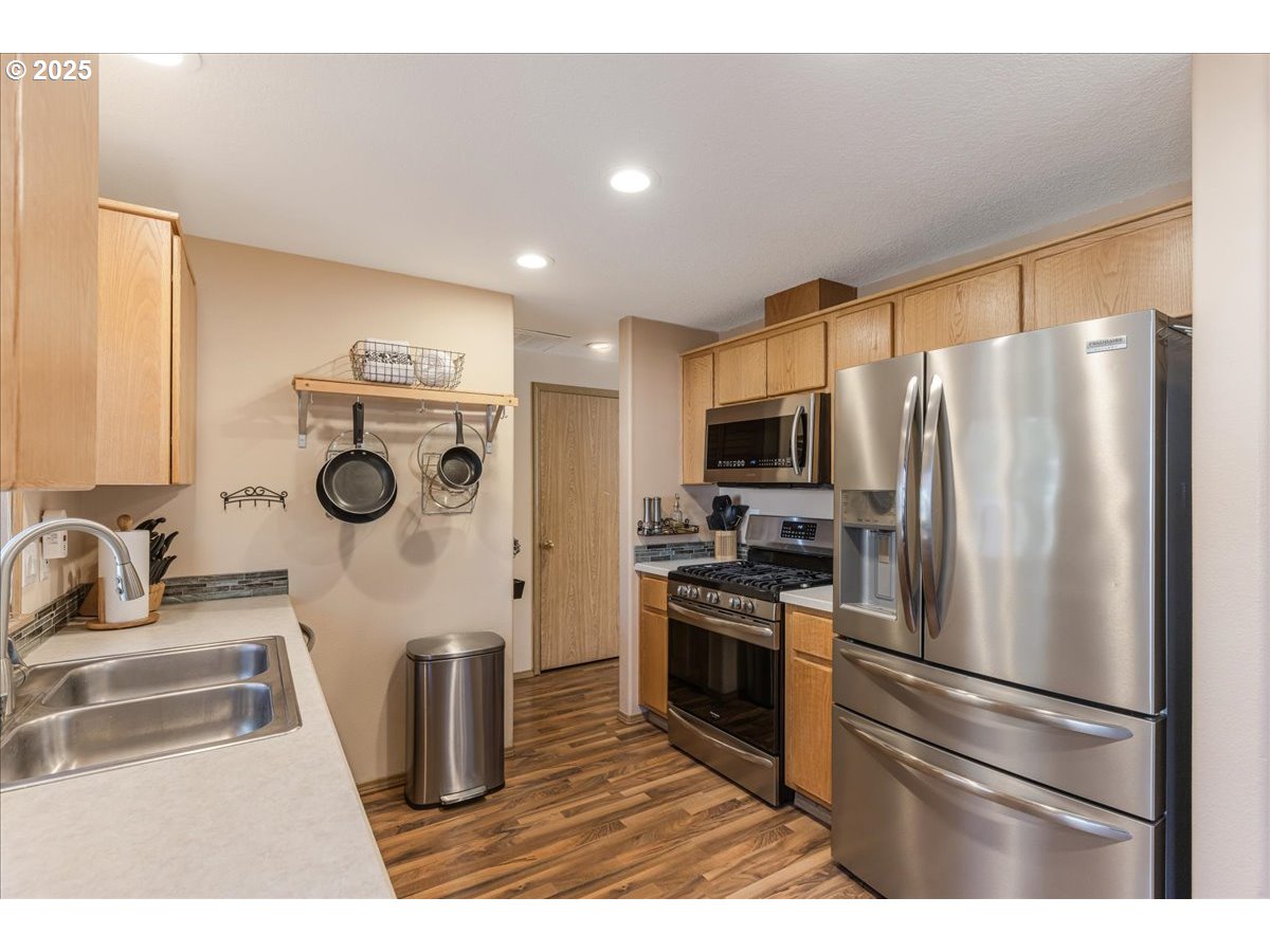3977 Southeast Salquist Road Gresham, OR 97080 - Photo 32 of 33 a kitchen with stainless steel appliances a refrigerator sink and stove