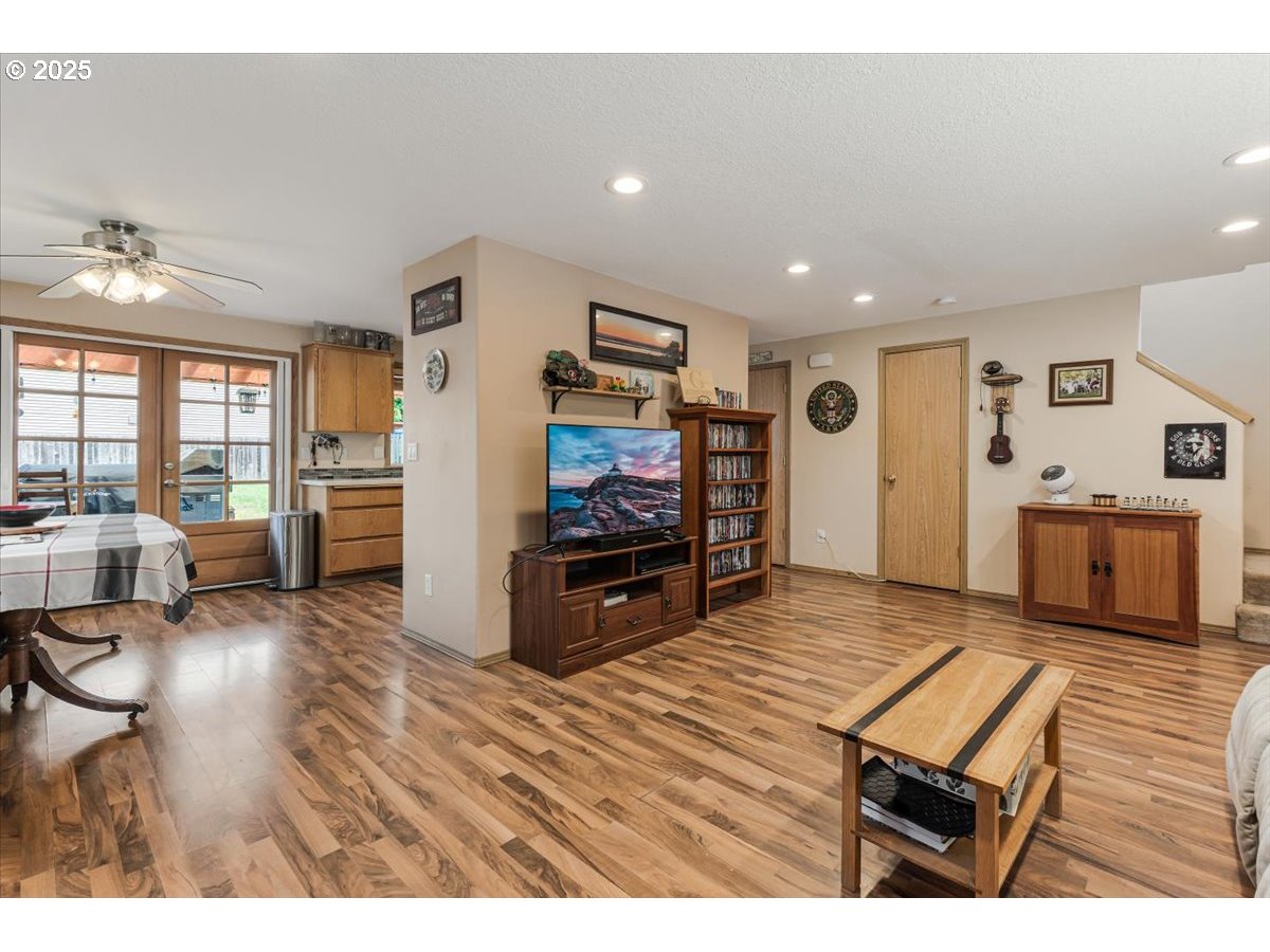 3977 Southeast Salquist Road Gresham, OR 97080 - Photo 7 of 33 a living room with furniture flat screen tv and wooden floor