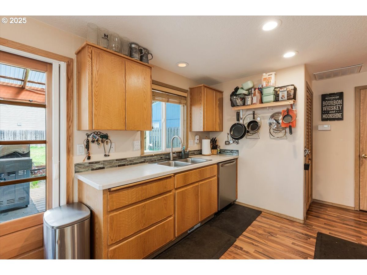 3977 Southeast Salquist Road Gresham, OR 97080 - Photo 10 of 33 a kitchen with a sink a stove and cabinets