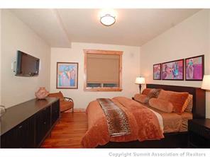 504 Ridge Street, Unit 504 Breckenridge, CO 80424 - Photo 11 of 17 a bedroom with two beds and a flat screen tv