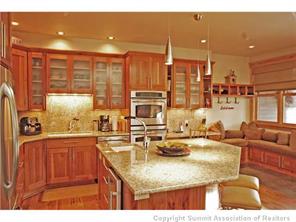 504 Ridge Street, Unit 504 Breckenridge, CO 80424 - Photo 6 of 17 a kitchen with kitchen island granite countertop a sink and counter top space
