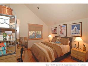 504 Ridge Street, Unit 504 Breckenridge, CO 80424 - Photo 9 of 17 a bedroom with a bed and glass windows