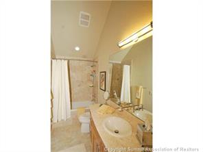 504 Ridge Street, Unit 504 Breckenridge, CO 80424 - Photo 10 of 17 a bathroom with a granite countertop sink a mirror and a bathtub