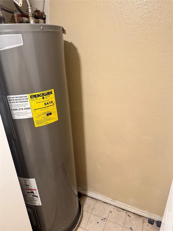 5617 Mansfield Road Arlington, TX 76017 - Photo 13 of 15 Gray water heater with Energy Guide label
