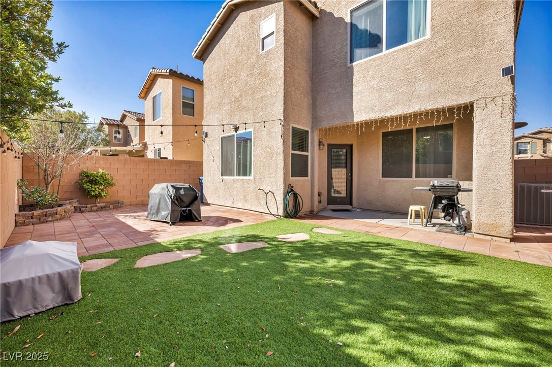 854 Earth Luster Road Las Vegas, NV 89178 - Photo 11 of 65 Back of house with a yard, a patio area, a fenced backyard, and stucco siding