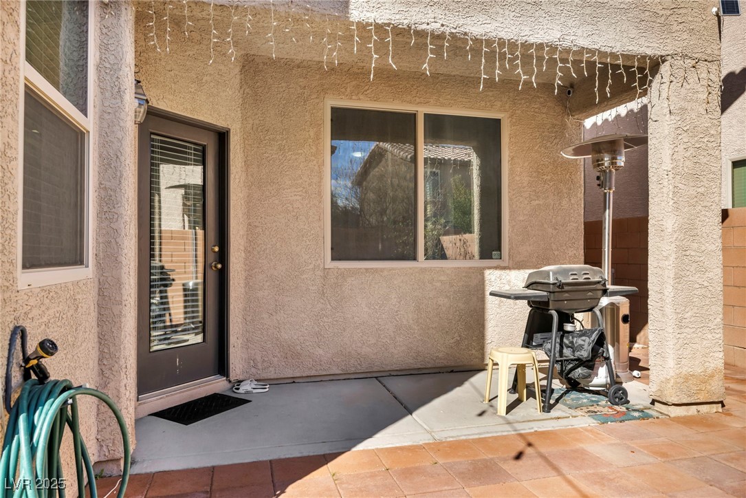 854 Earth Luster Road Las Vegas, NV 89178 - Photo 18 of 65 Entrance to property with a patio area and stucco siding