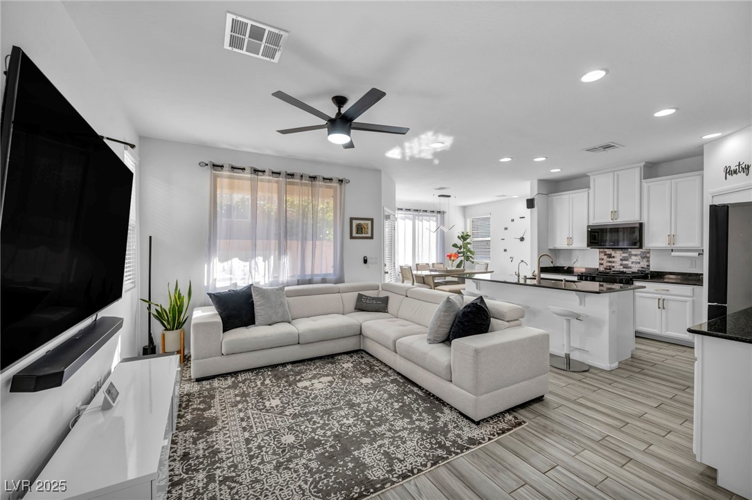 854 Earth Luster Road Las Vegas, NV 89178 - Photo 19 of 65 Living room featuring a ceiling fan, recessed lighting, visible vents, and light wood-style flooring