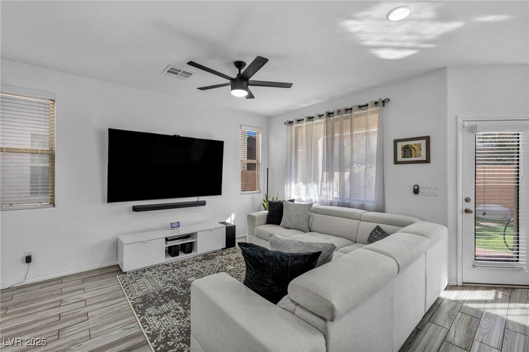 854 Earth Luster Road Las Vegas, NV 89178 - Photo 20 of 65 Living area with wood tiled floor, visible vents, and ceiling fan