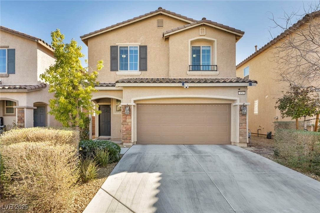 854 Earth Luster Road Las Vegas, NV 89178 - Photo 2 of 65 Mediterranean / spanish-style home featuring a garage, concrete driveway, a tiled roof, and stucco siding