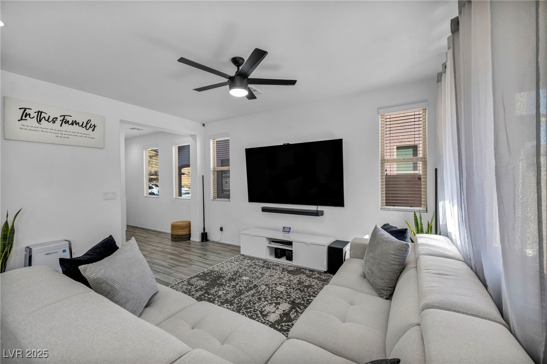 854 Earth Luster Road Las Vegas, NV 89178 - Photo 21 of 65 Living room featuring a ceiling fan and light wood finished floors