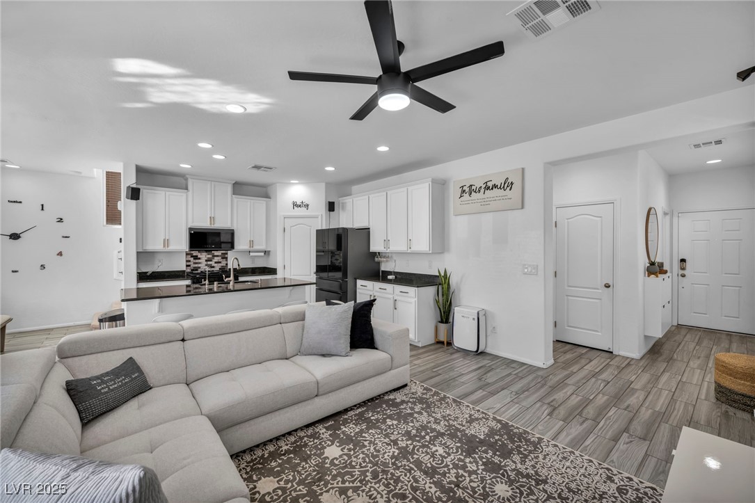 854 Earth Luster Road Las Vegas, NV 89178 - Photo 22 of 65 Living area with light wood-style floors, visible vents, and recessed lighting