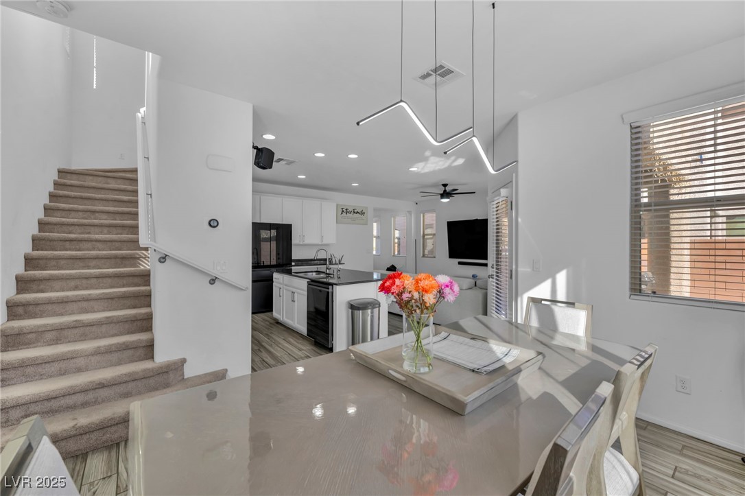854 Earth Luster Road Las Vegas, NV 89178 - Photo 29 of 65 Dining area featuring light wood-style flooring, wine cooler, visible vents, and stairway