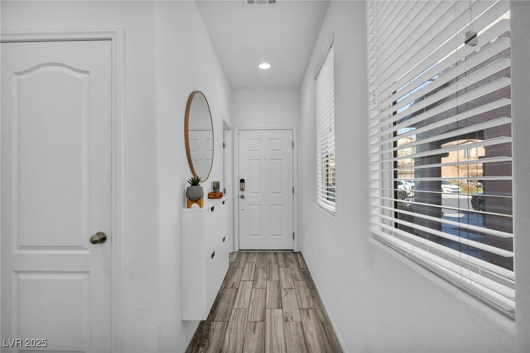 854 Earth Luster Road Las Vegas, NV 89178 - Photo 31 of 65 Hall with wood finish floors and visible vents