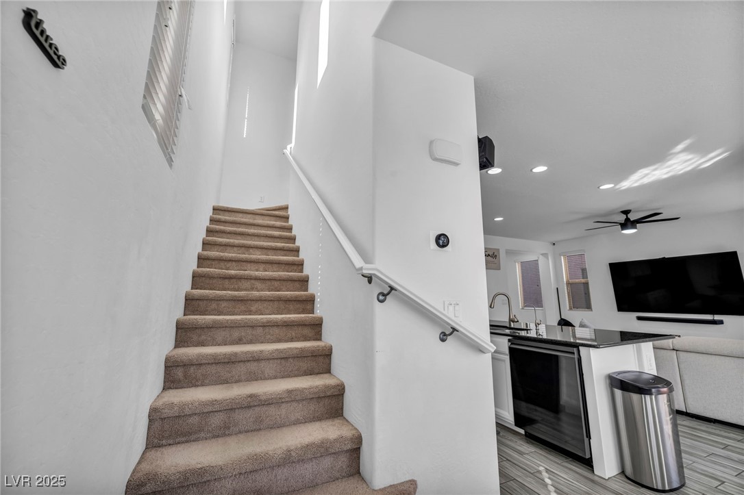 854 Earth Luster Road Las Vegas, NV 89178 - Photo 33 of 65 Stairway featuring ceiling fan, wood finished floors, and recessed lighting