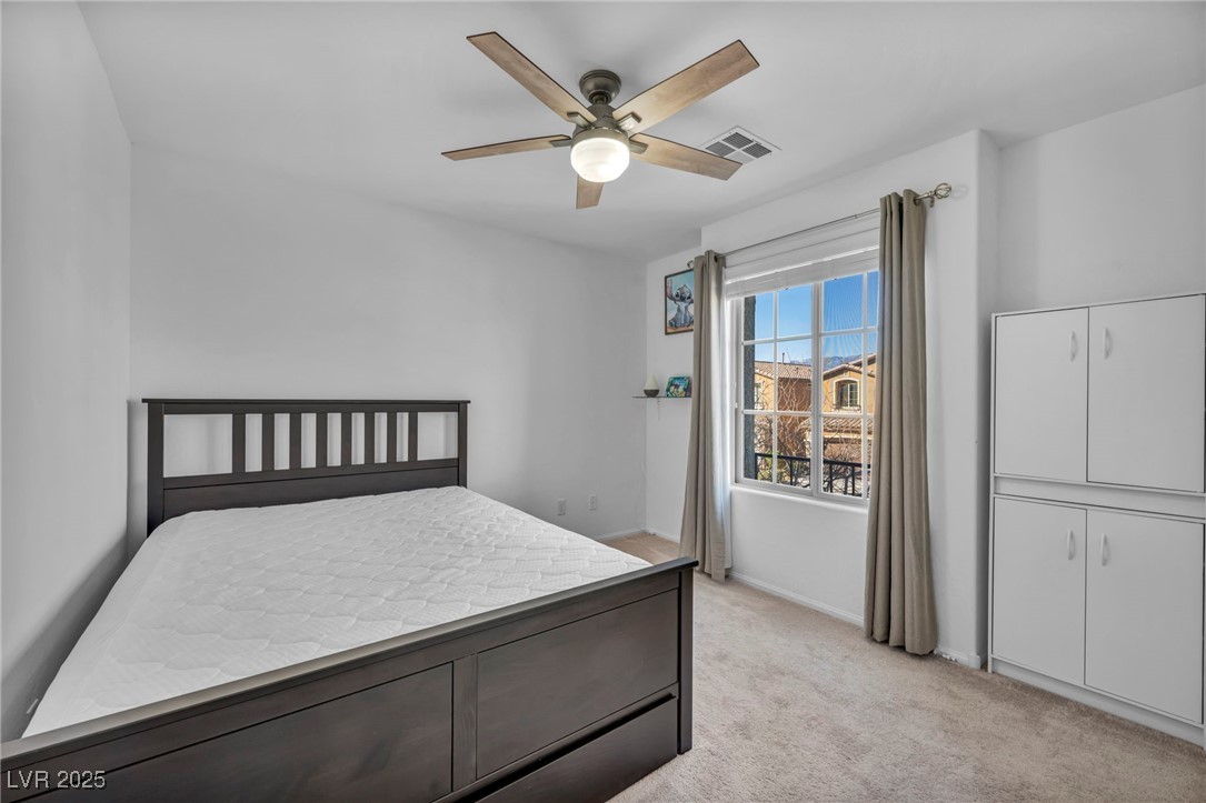 854 Earth Luster Road Las Vegas, NV 89178 - Photo 34 of 65 Bedroom with light carpet, ceiling fan, and visible vents